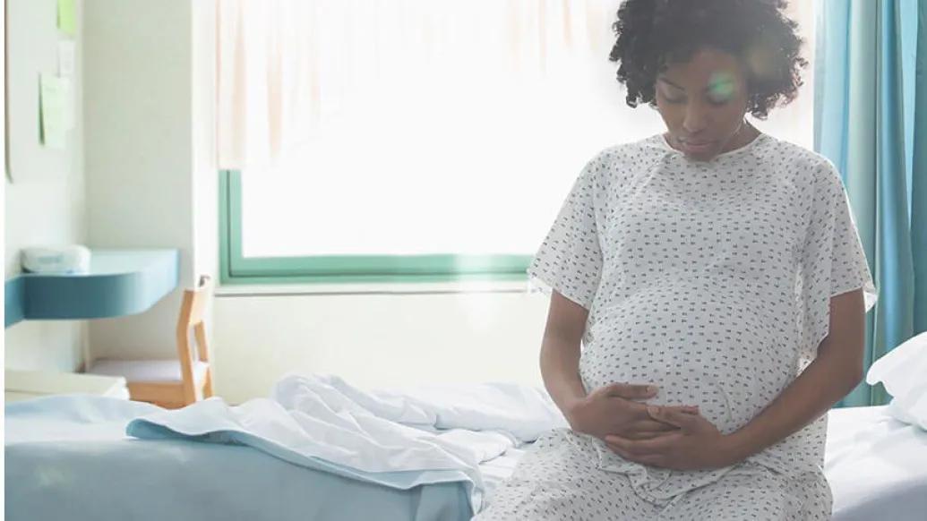Pregnant women in hospital gown in a hospital room
