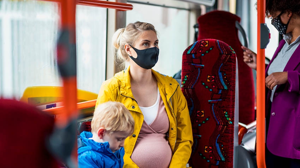 pregnant woman on bus with child