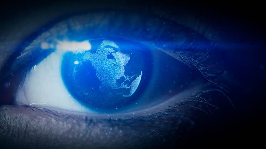 Pupil of eye with world map being reflected in the eye