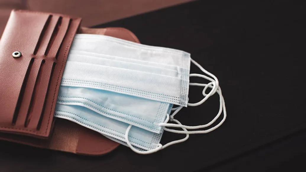 brown wallet with face masks