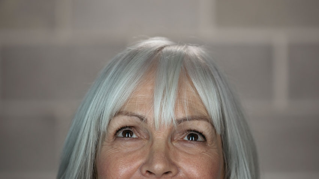 Woman with white hair looking up