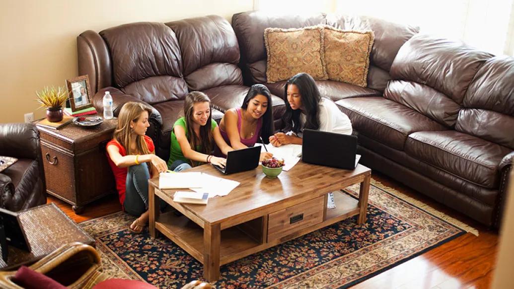 teenage girls studying in pod in family room