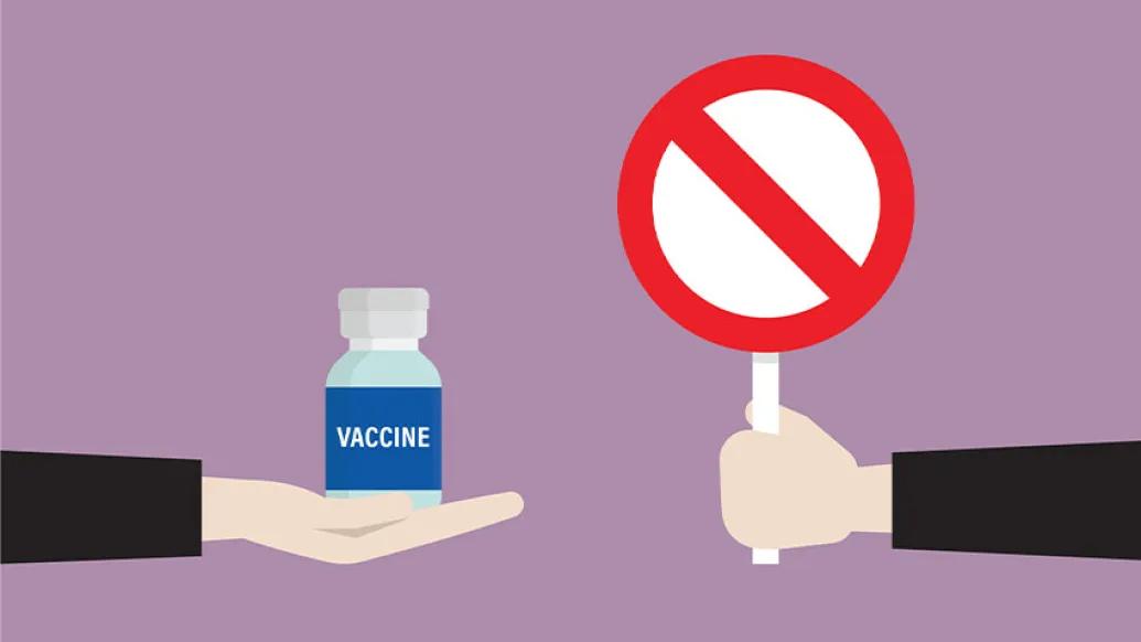 Hand holding stop symbol and a hand holding vaccine pill bottle.