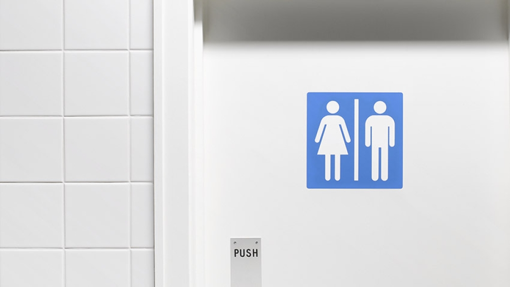 white bathroom door with blue gender sign