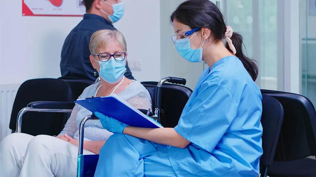 woman sitting with clinician in waiting room