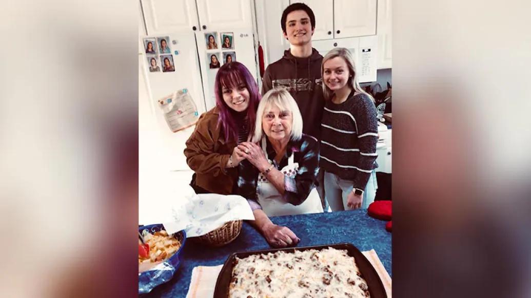 Woman in kitchen with grandchildren