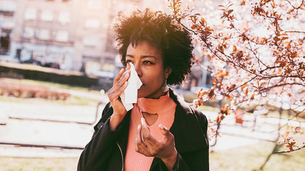 Women with kleenex wiping tear from fall allergies