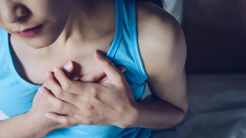 Young women holding her chest near heart