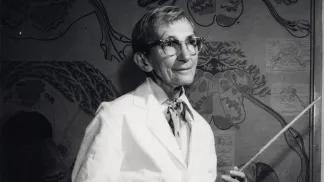 Photo of Elizabeth Crosby holding a pointer in a classroom
