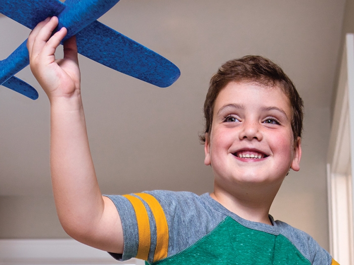 Carter plays with a toy airplane