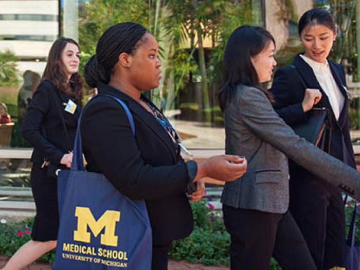 Asian and Black female medical school students walking on campus