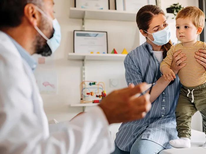 Mother with a toddler talking to a doctor