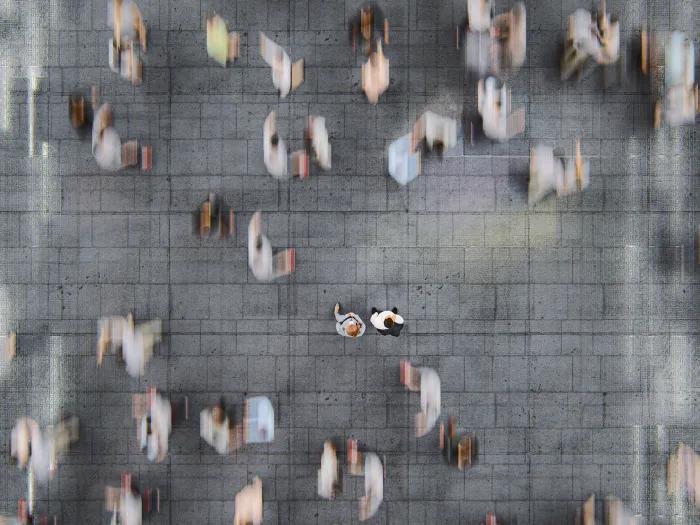crowded blurred people walking in city streets