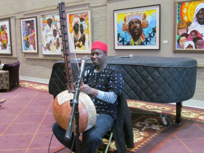 A kora player performs a song