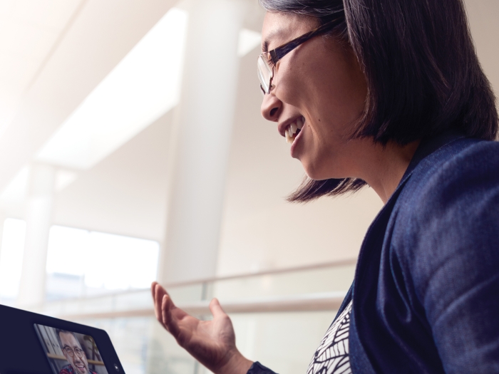 Dr. Allison Lin holding a telehealth appointment with a male patient