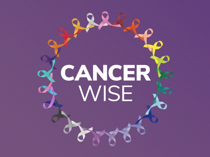Cancer Wise in a circle of mutl-colored ribbons on a purple background