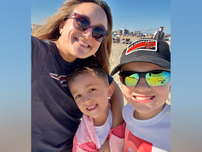 Selfie picture of woman and two kids at the beach