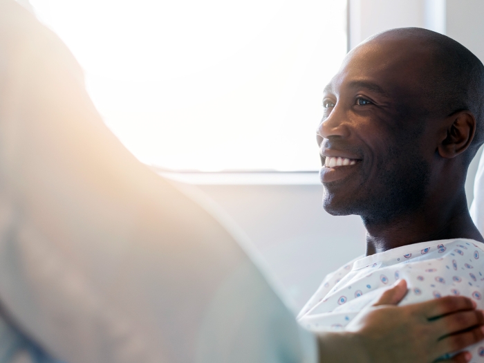 black male in hospital bed smiling