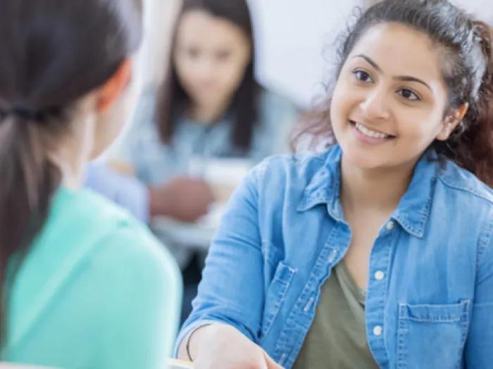 Stock photo of two people engaged in coversation