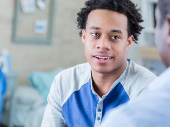 Stock photo of a young person and a professional in conversation