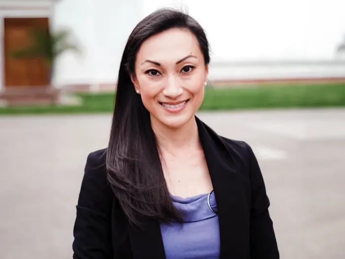 headshot of alice zheng wearing a black blazer and purple blouse
