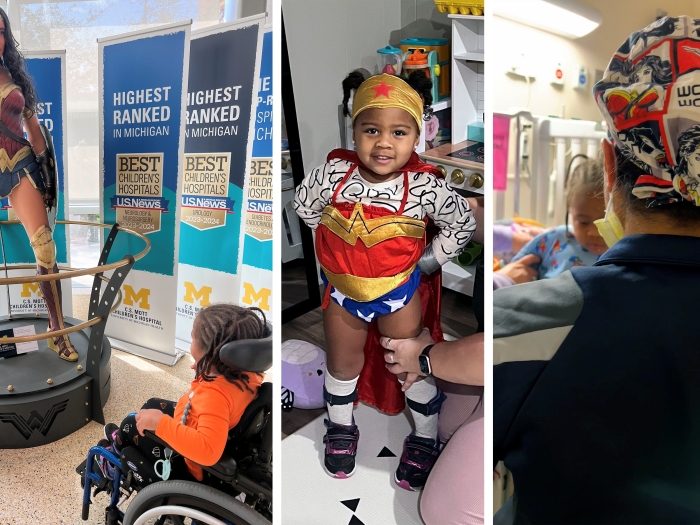 Three year old patient poses by Wonder Woman statue, wears costume