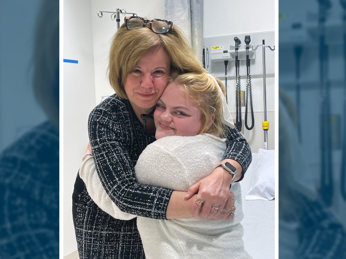 woman hugging patient in exam room