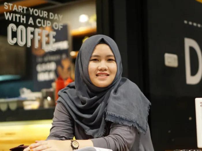 Teen girl in hijab smiles