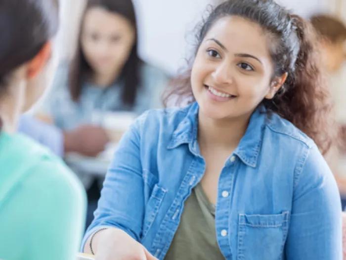 Teen girl speaks with another teen