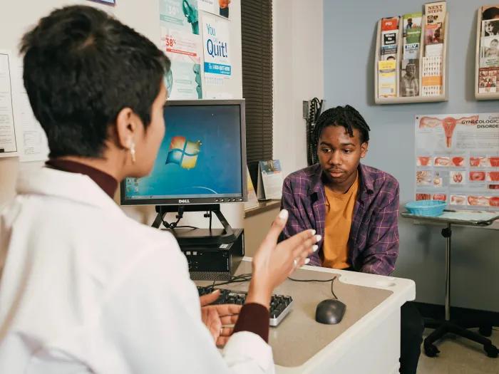 Dr. Nash speaks with a young patient