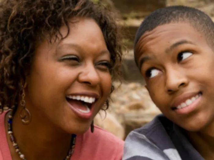 teen girl laughs with teen boy