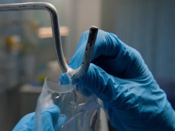 blue gloves in hospital hanging IV bag