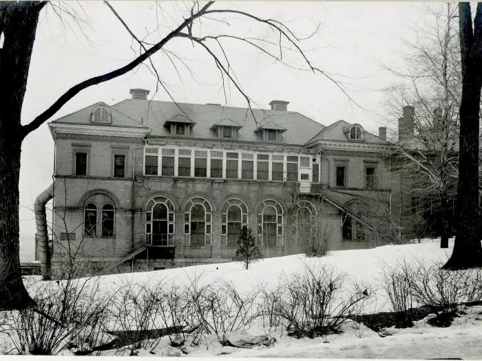 Black and white photo of the Palmer Ward for pediatrics that was part of the old University Hospital campus before "Old Main" was built in the 1930s. It's a 3-story building with large arched windows in front.