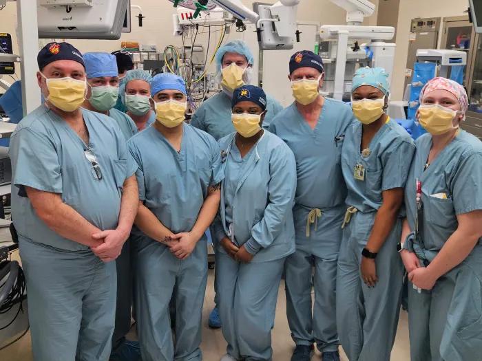 The surgical team poses in the OR after the first implantation for the trial at U-M.