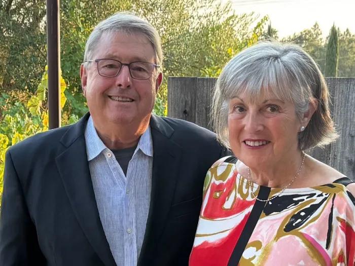 David and Linda Bachrach smile as they stand together outside.