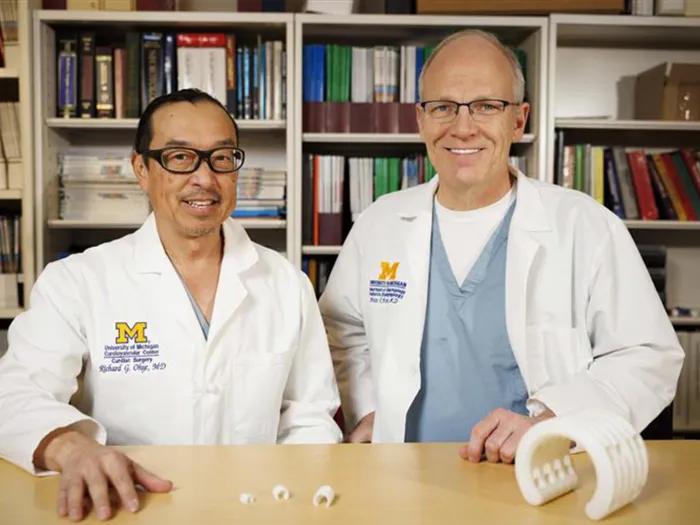 Richard Ohye, M.D., and Glenn Green, M.D., from Michigan Medicine and University of Michigan Health C.S. Mott Children’s Hospital with a bioresorbable, 3D-printed tracheobronchial splint device educational model – original size (left) and augmented model (right) 