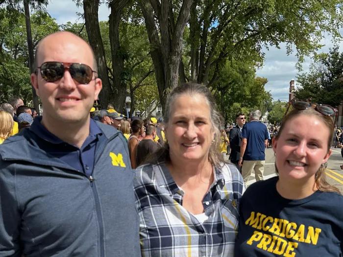 Smiling photo of the Cozads on a sunny day at a campus event.