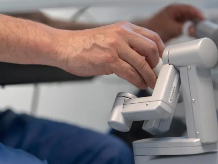hands on a robotic handle for surgery
