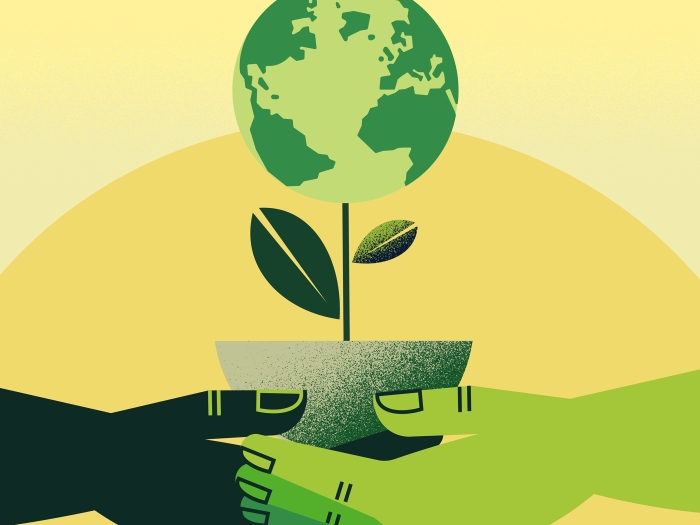 Two hands holding potted plant with earth blooming. 