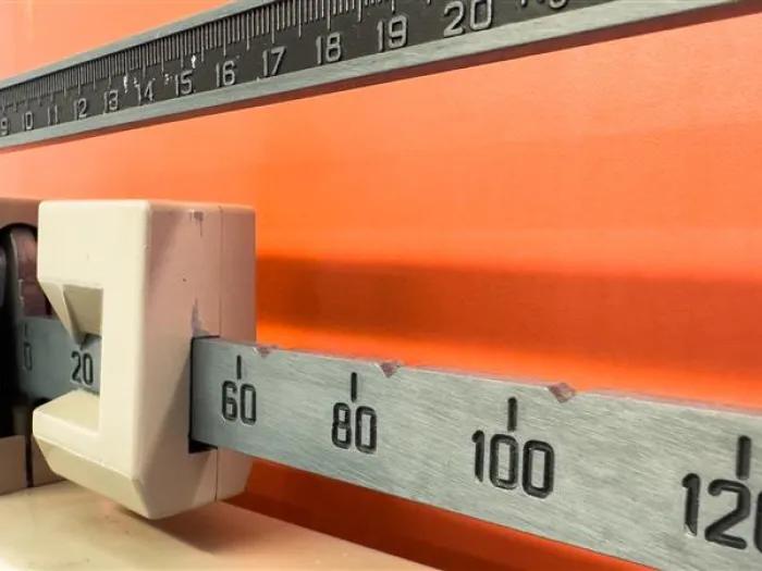 scale close up of numbers orange wall