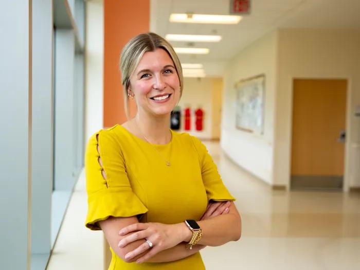 woman smiling at camera in yellow