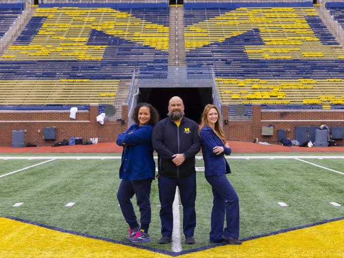 3 nurses standing centerfield at Michigan Stadium