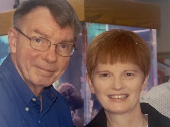 Portraits of Lee Feldkamp and Rose O'Connor standing together. Rose is holding a small glass, suggesting they are at a special event.