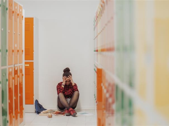 yellow orange green lockers girl upset sitting