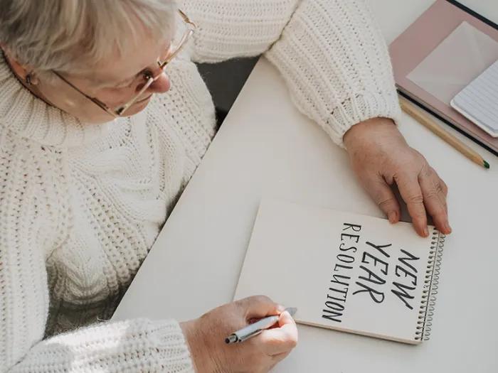 Older woman making new year's resolutions