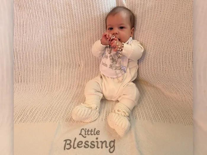 baby on blanket saying little blessing