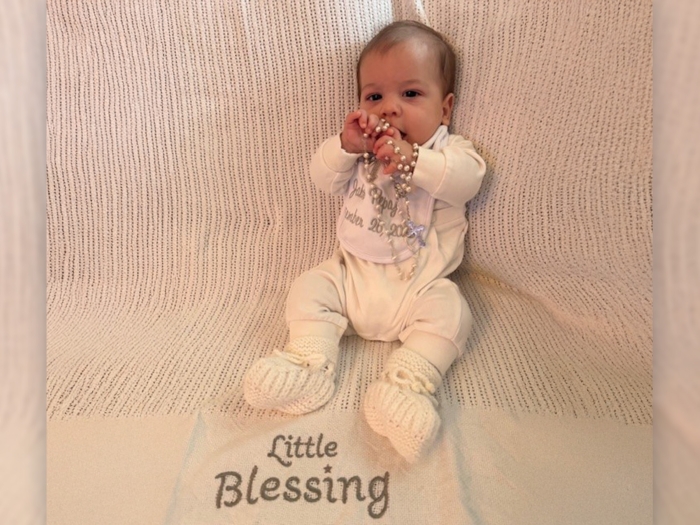 baby on blanket saying little blessing