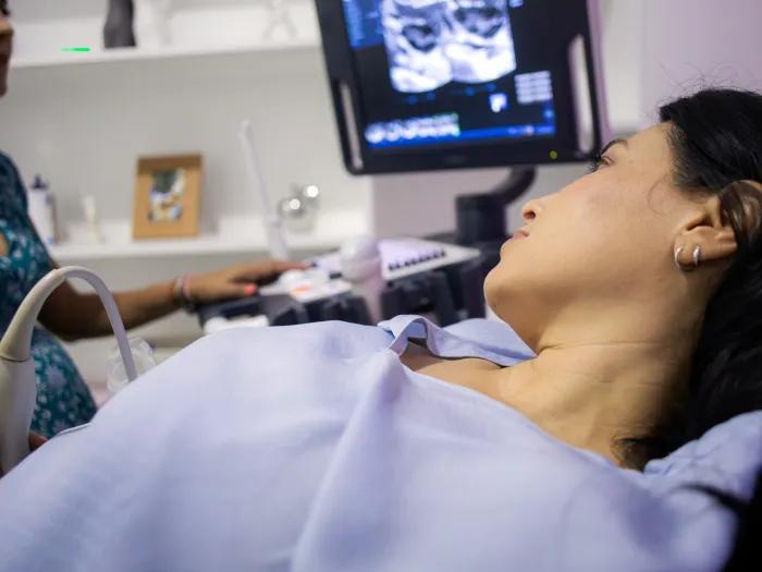 girl laying on chair with scan on screen with provider