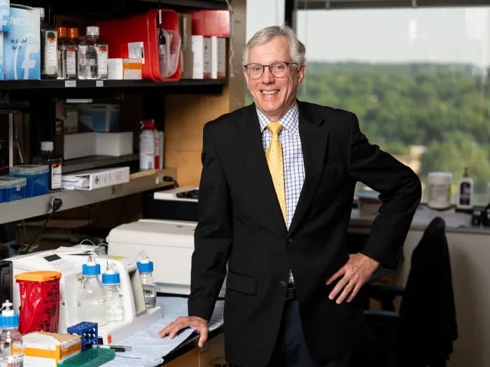 Daniel Hayes poses for a photo in a lab