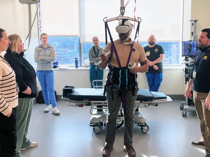 team standing around person using virtual reality headset